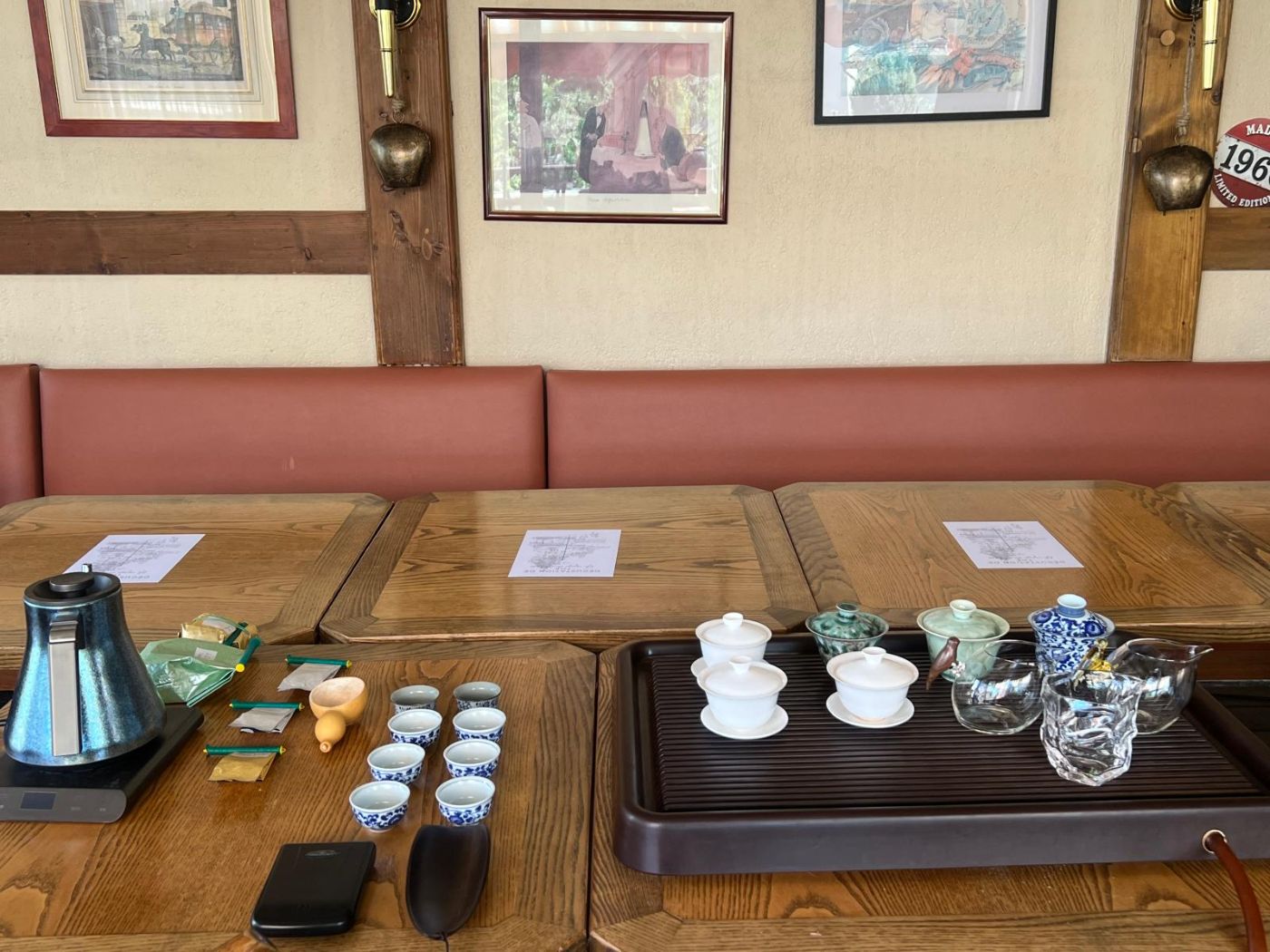 A gongfu tasting set, gaiwans, cups and tasting menus laid out in Geneva