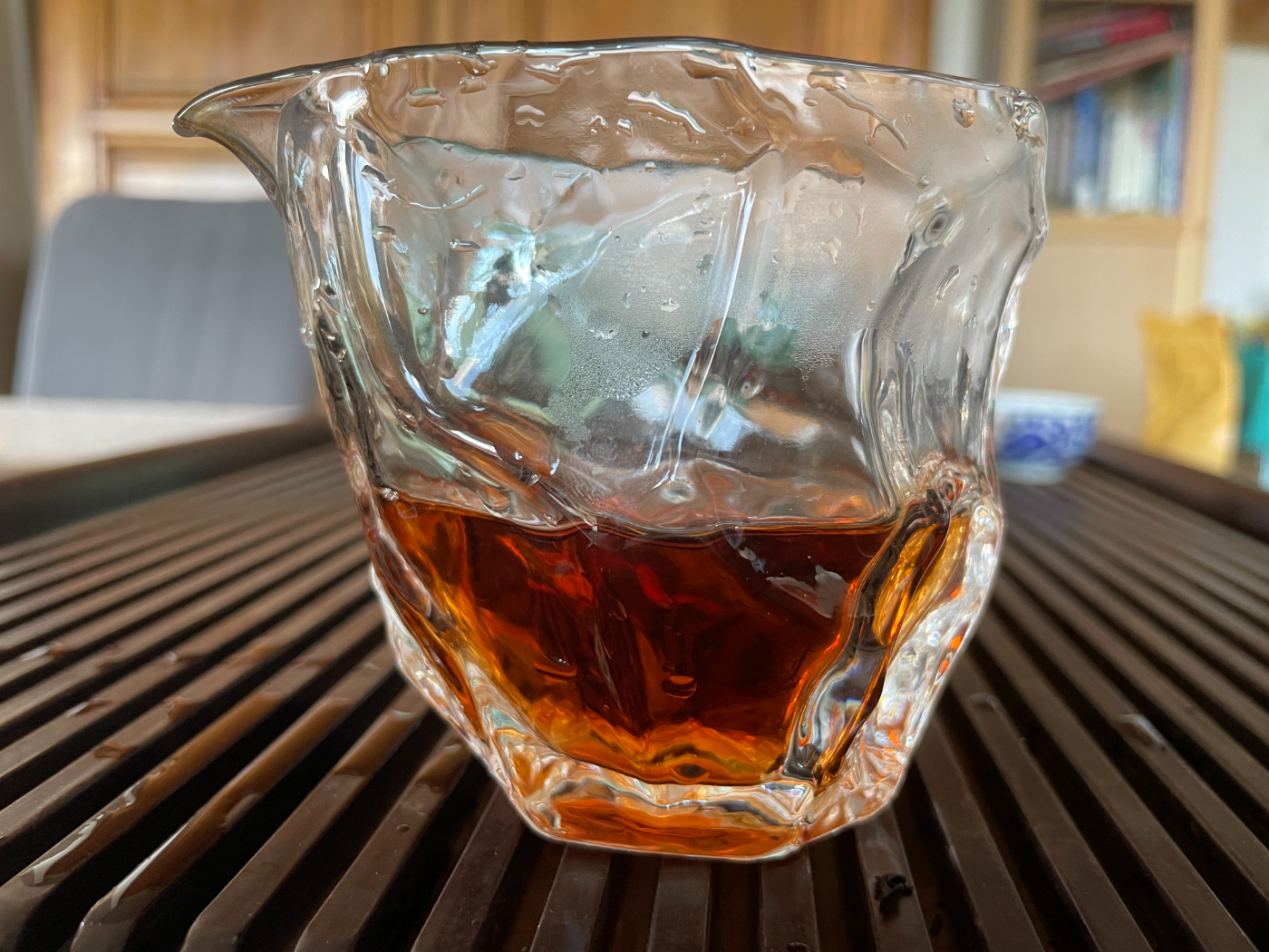 Clear orange-red liquor in a glass pitcher