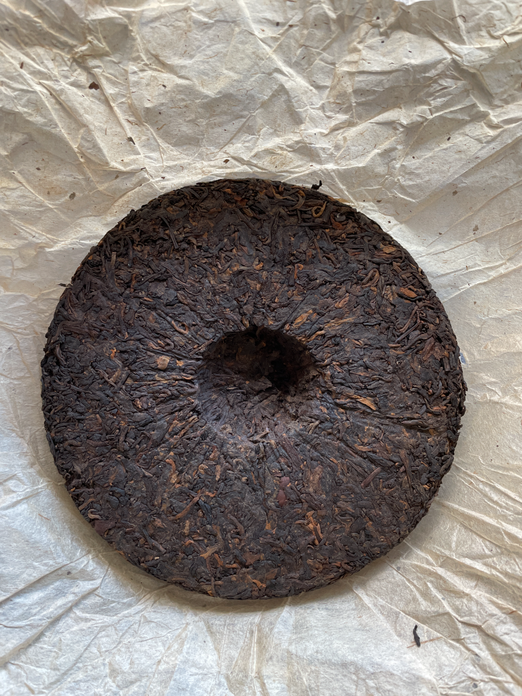 The bare compressed cake of dark wild leaves
