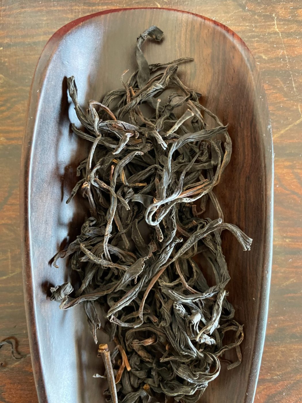 Wild Red, twisted dark leaves in a wooden tray